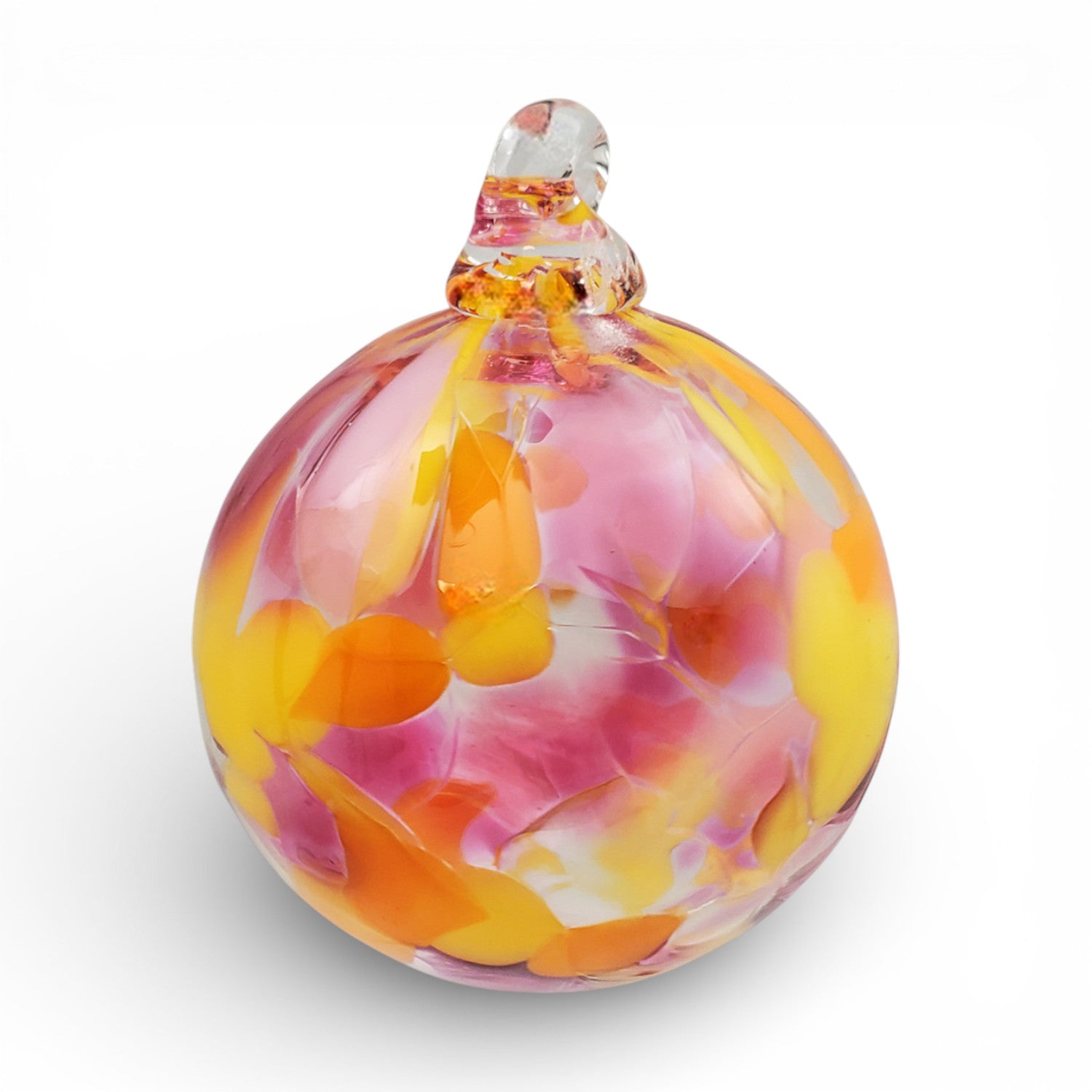 Colorful glass ornament with pink and orange swirls on a white background