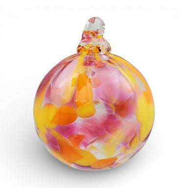 Colorful glass ornament with pink and orange swirls on a white background