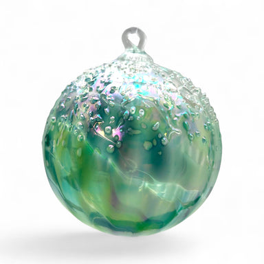 Decorative glass ornament with green and blue swirls on a white background