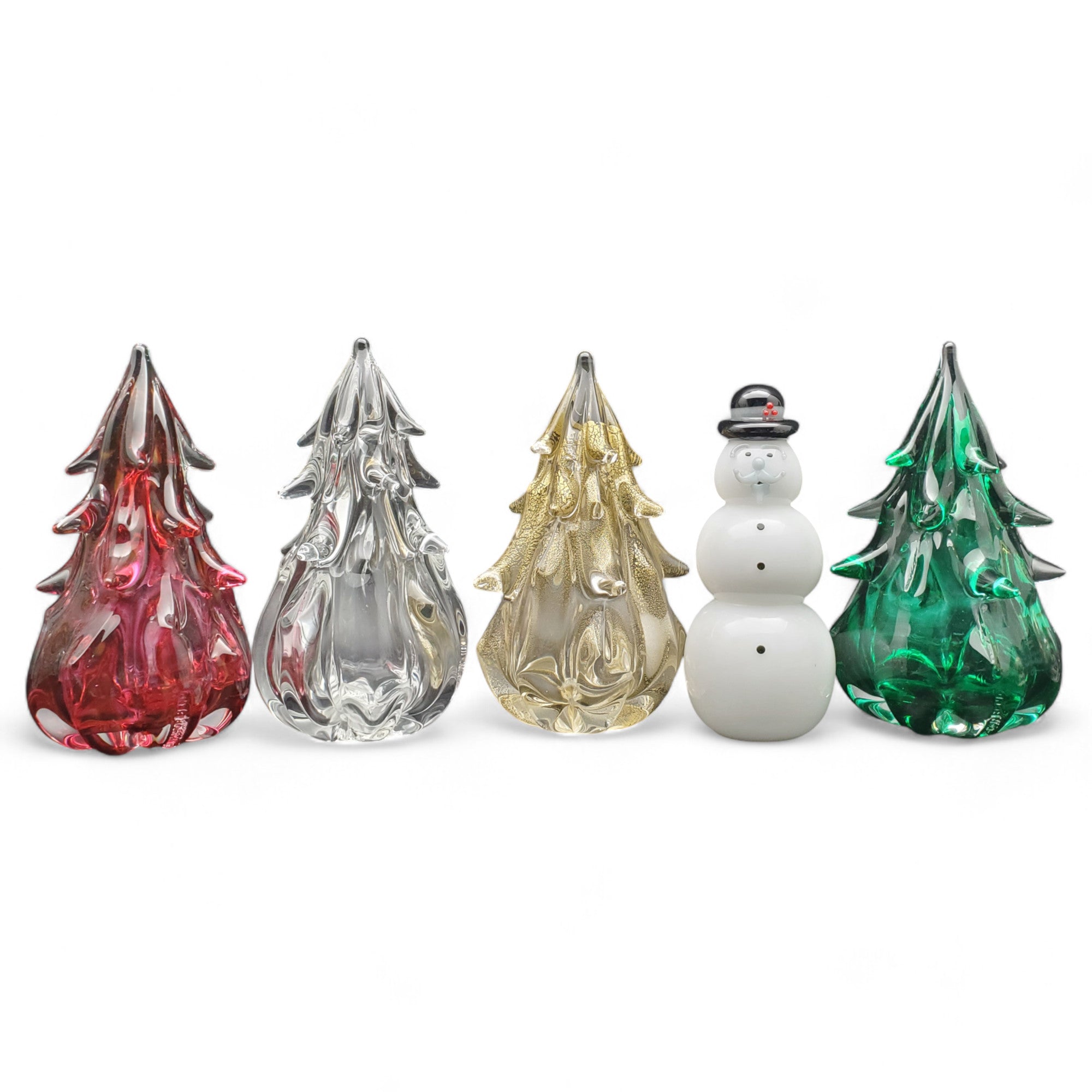 A set of medium-sized hand blown glass trees in various colors including red, green, clear, and gold leaf, with a snowman-shaped glass figurine in the background.