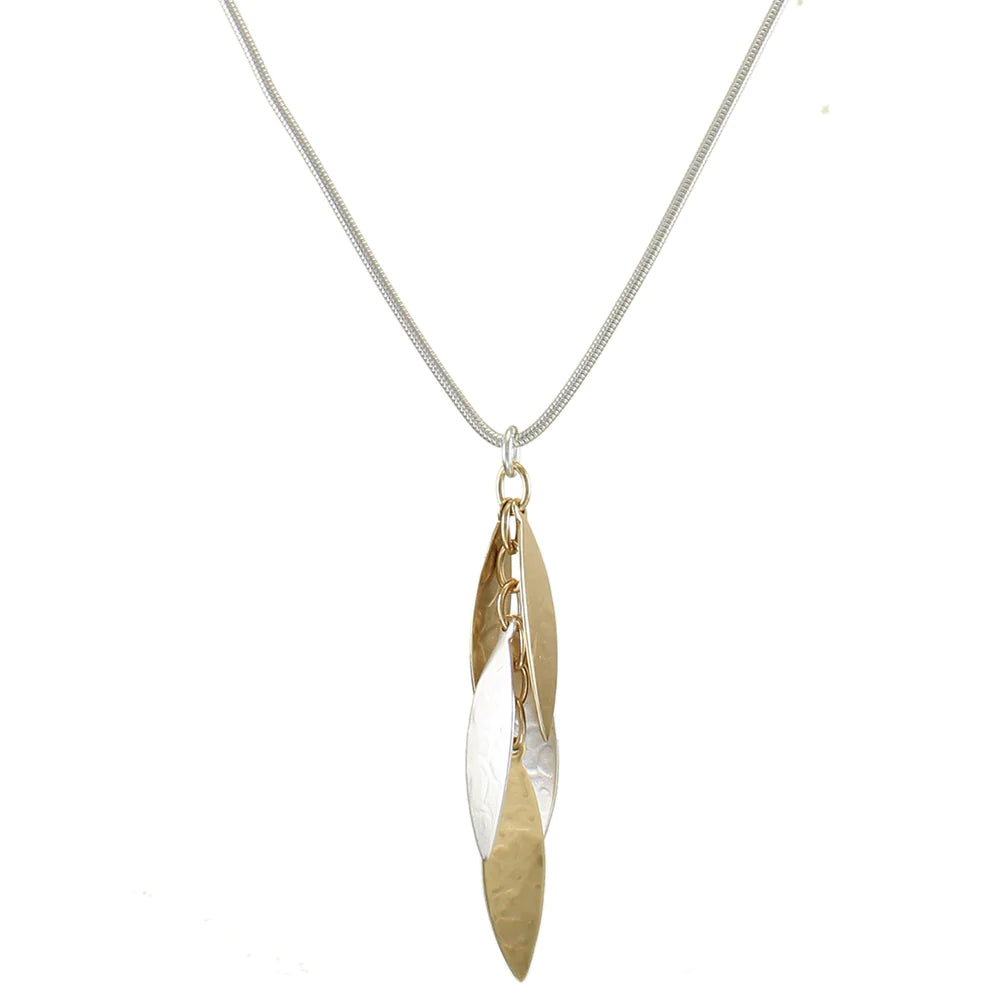 A layered leaves necklace with brass and silver leaves on a silver round snake chain with a lobster claw closure.