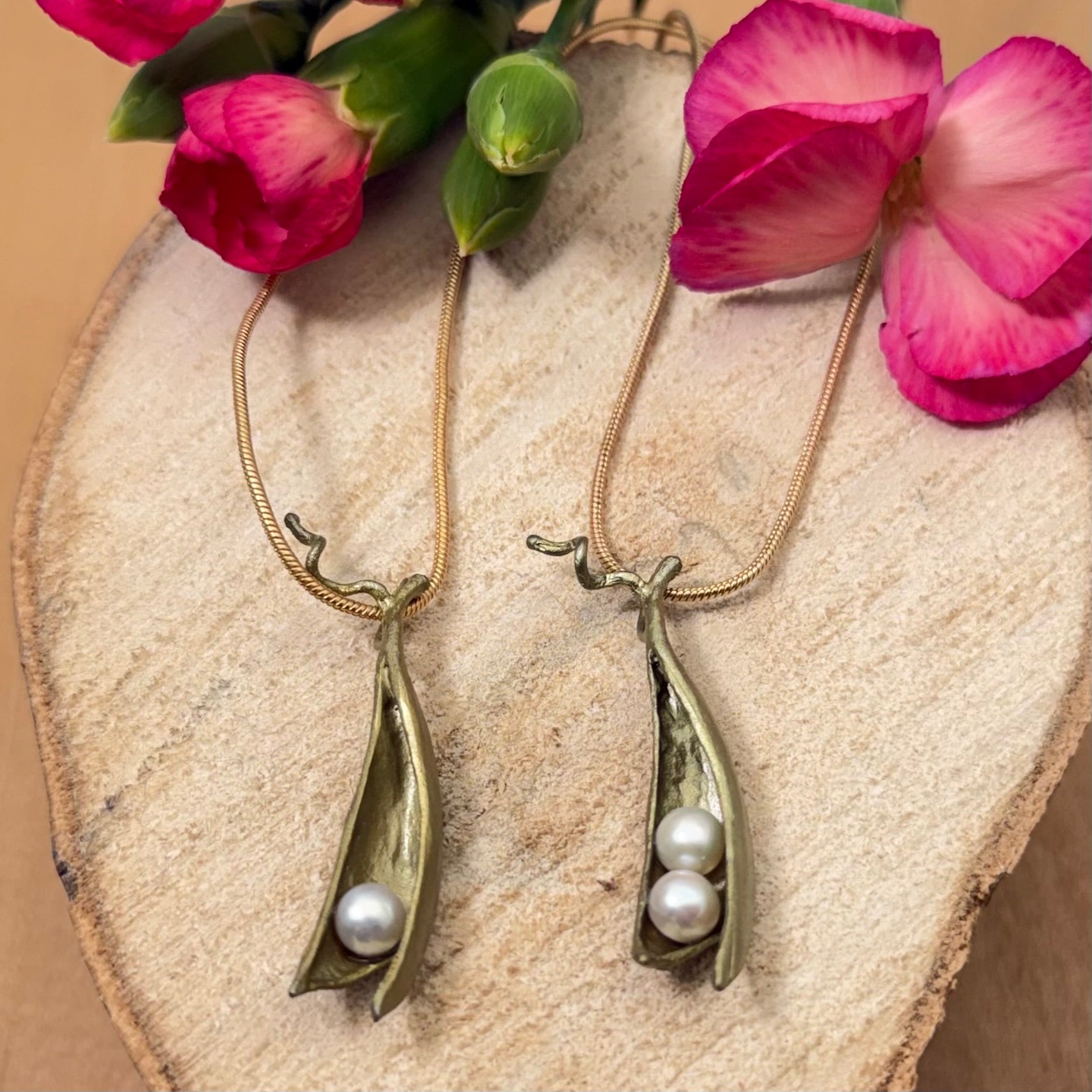 two handcrafted pea pod necklaces with freshwater pearls