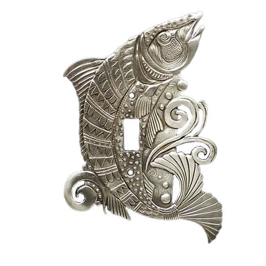 A pewter switch plate featuring an intricate salmon design with a shiny finish and a central switch hole.