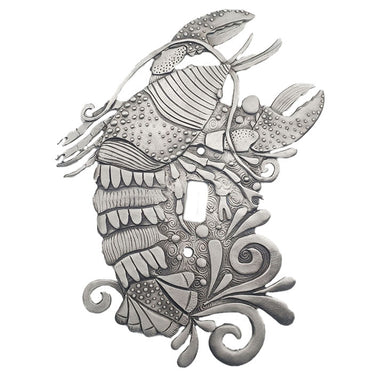 A silver-colored pewter switch plate with an intricate rock lobster design.