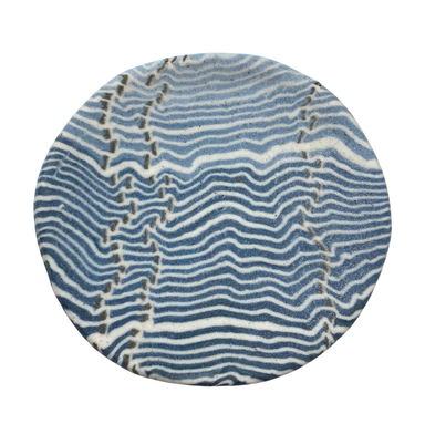 A round porcelain dish with a blue and white striped pattern.