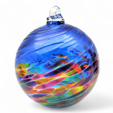Multicolored glass ornament with a blue top on a white background