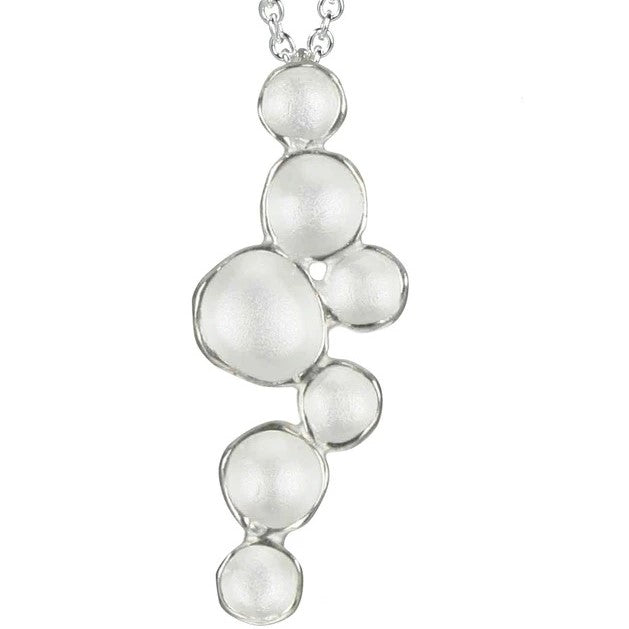 Silver bubble pendant necklace on a white background