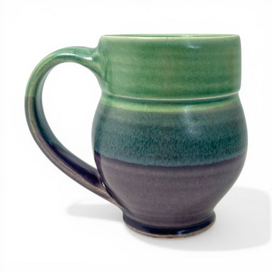 Green and purple ceramic mug on a white background