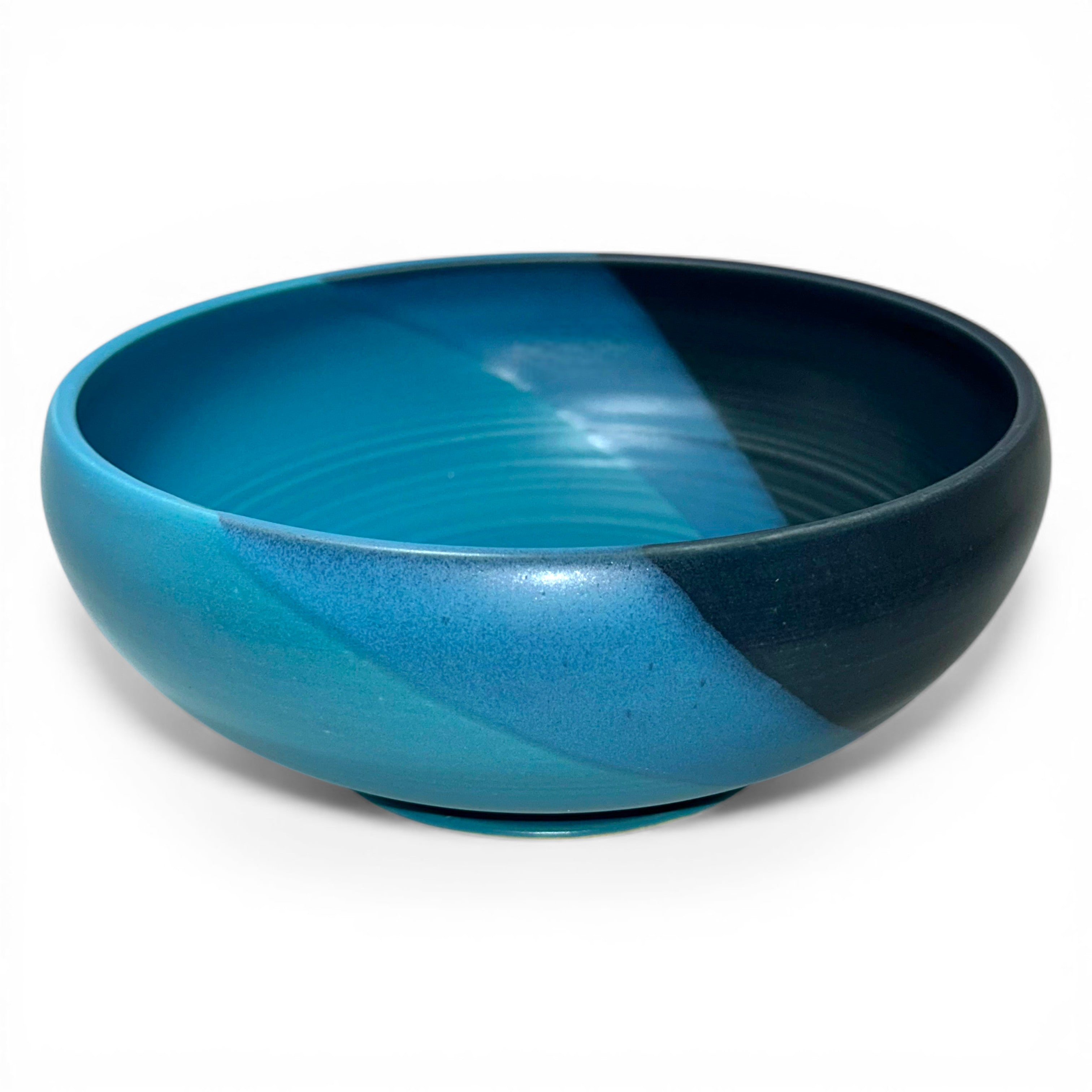colorful blue and turquoise serving bowl adds cheer and style to any dinner table