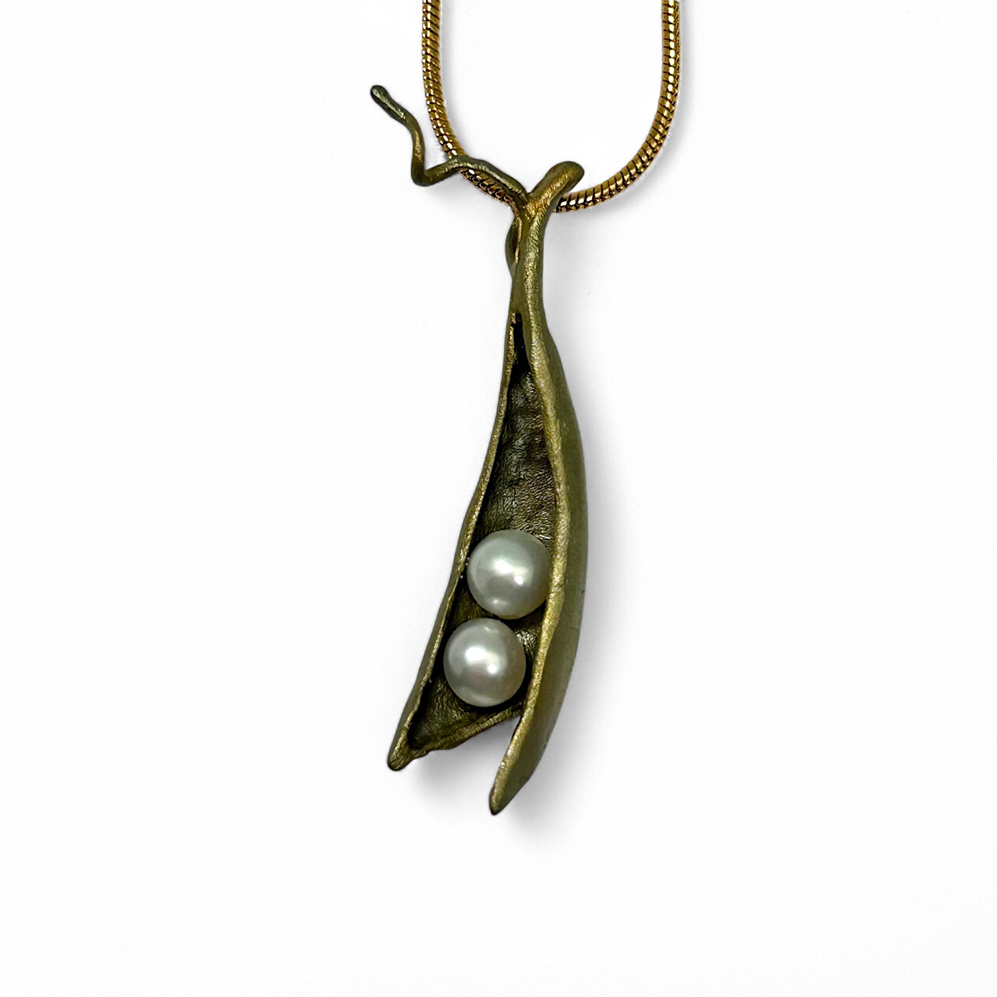 A cast bronze pea pod necklace with two freshwater pearls is a great reminder of the love that surrounds you