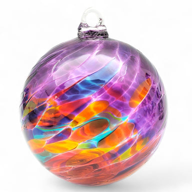 Colorful glass ornament with swirl patterns on a white background
