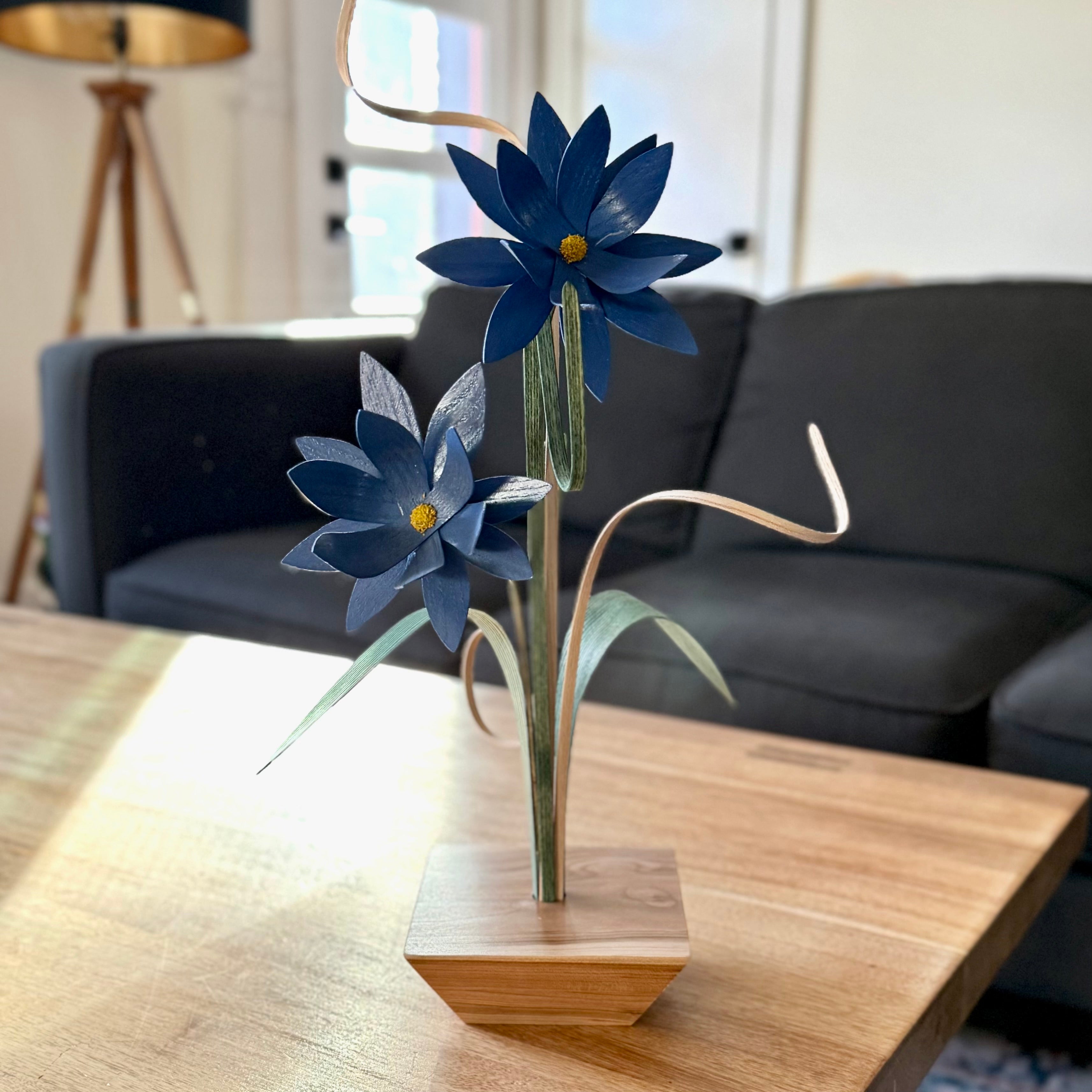 Decorative blue flowers handcrafted from hardwoods in a modern wooden base stay colorful all year long 