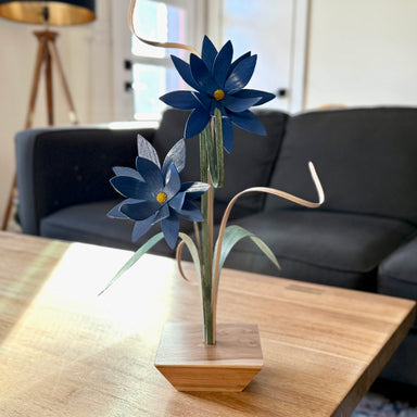 Decorative blue flowers handcrafted from hardwoods in a modern wooden base stay colorful all year long 