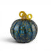A decorative hand-blown glass pumpkin ornament with a marbled blue and green body and a twisted yellow stem.  