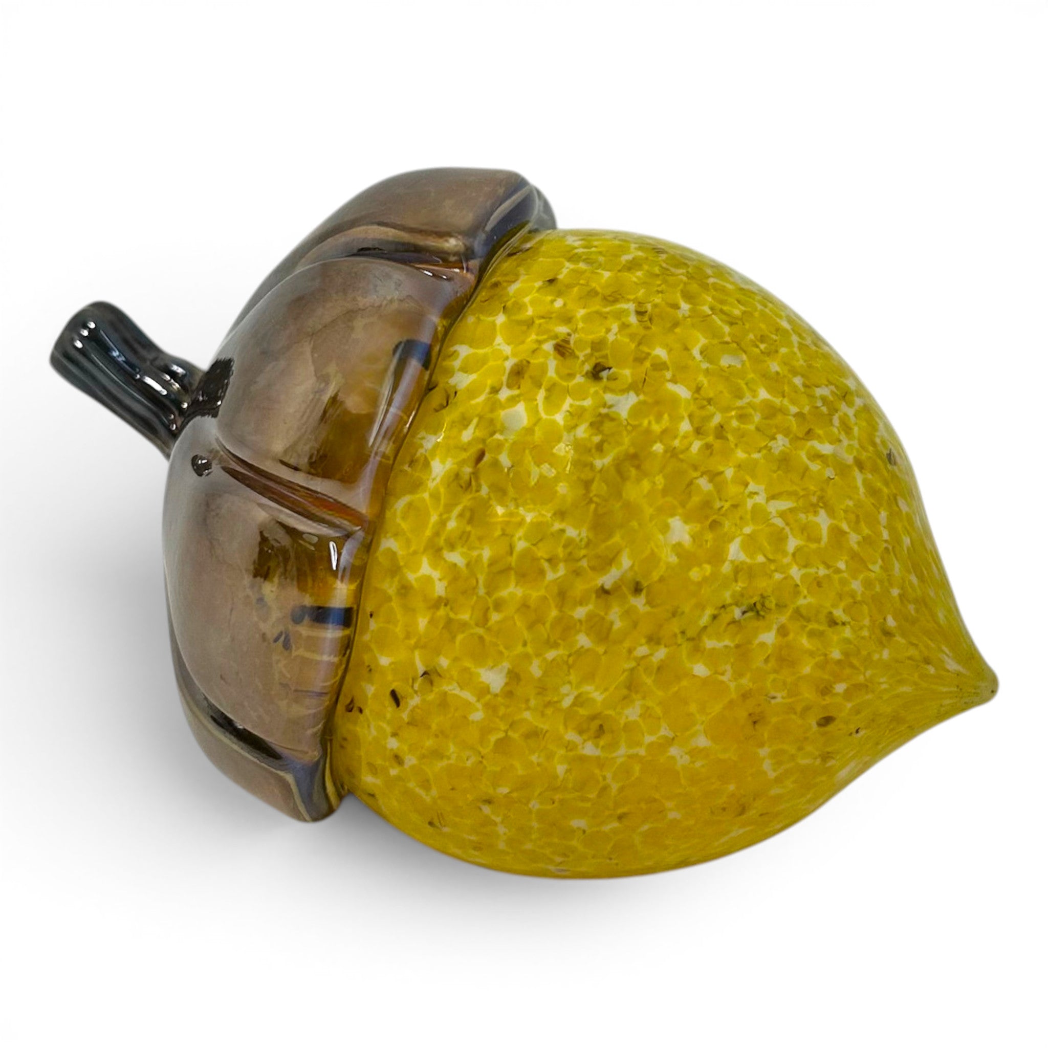 A decorative glass acorn sculpture with a textured yellow-green body and a glossy brown cap.
