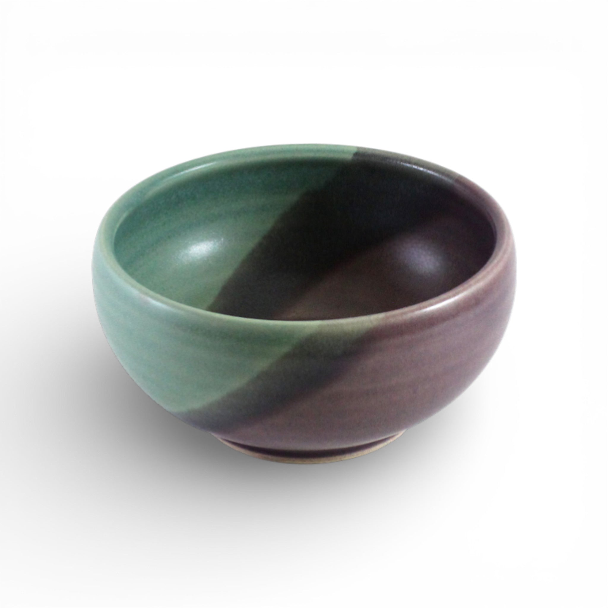 Two-toned ceramic bowl with green and purple colors on a white background