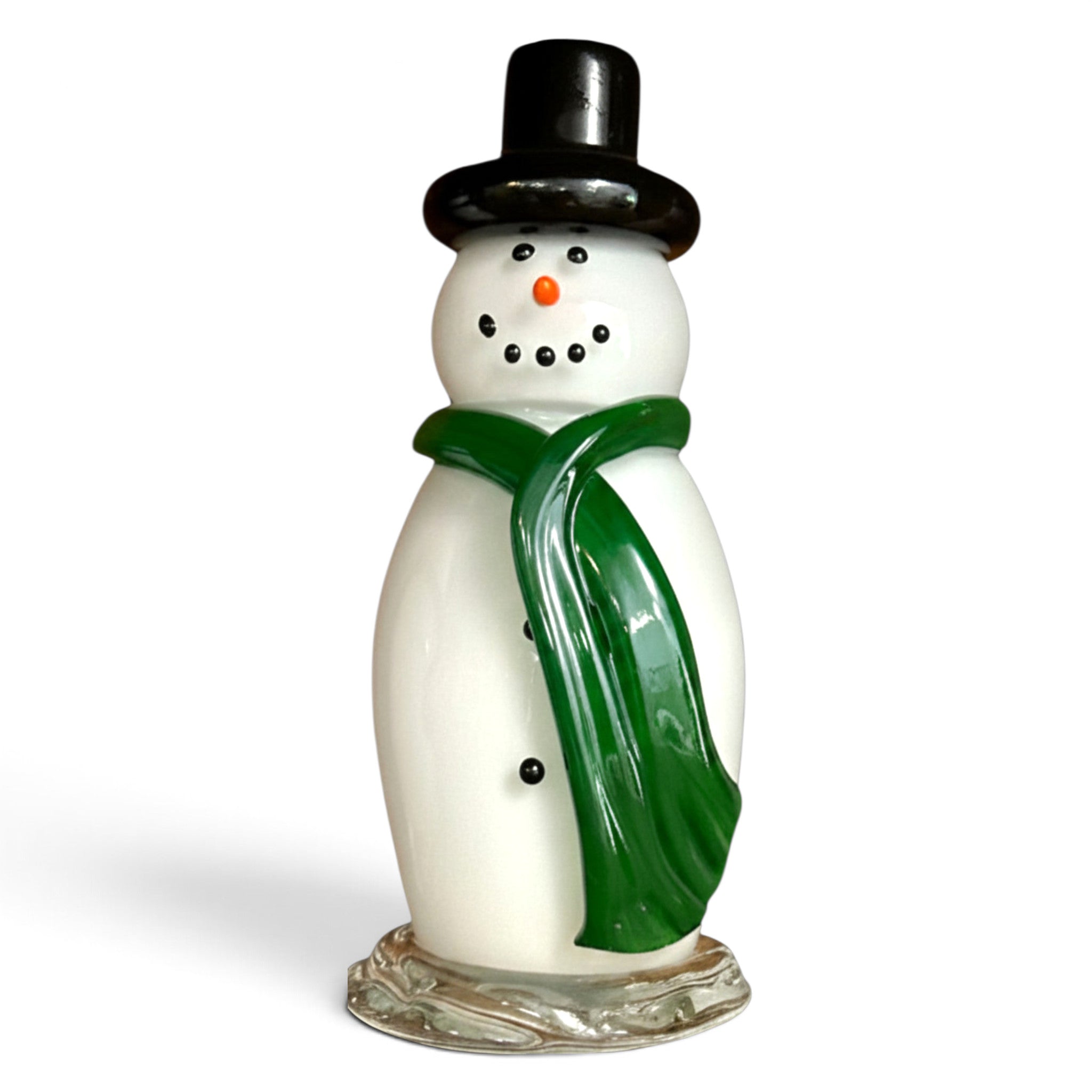 A vintage white handcrafted glass snowman figurine with a glossy green scarf, black top hat, and orange carrot nose.