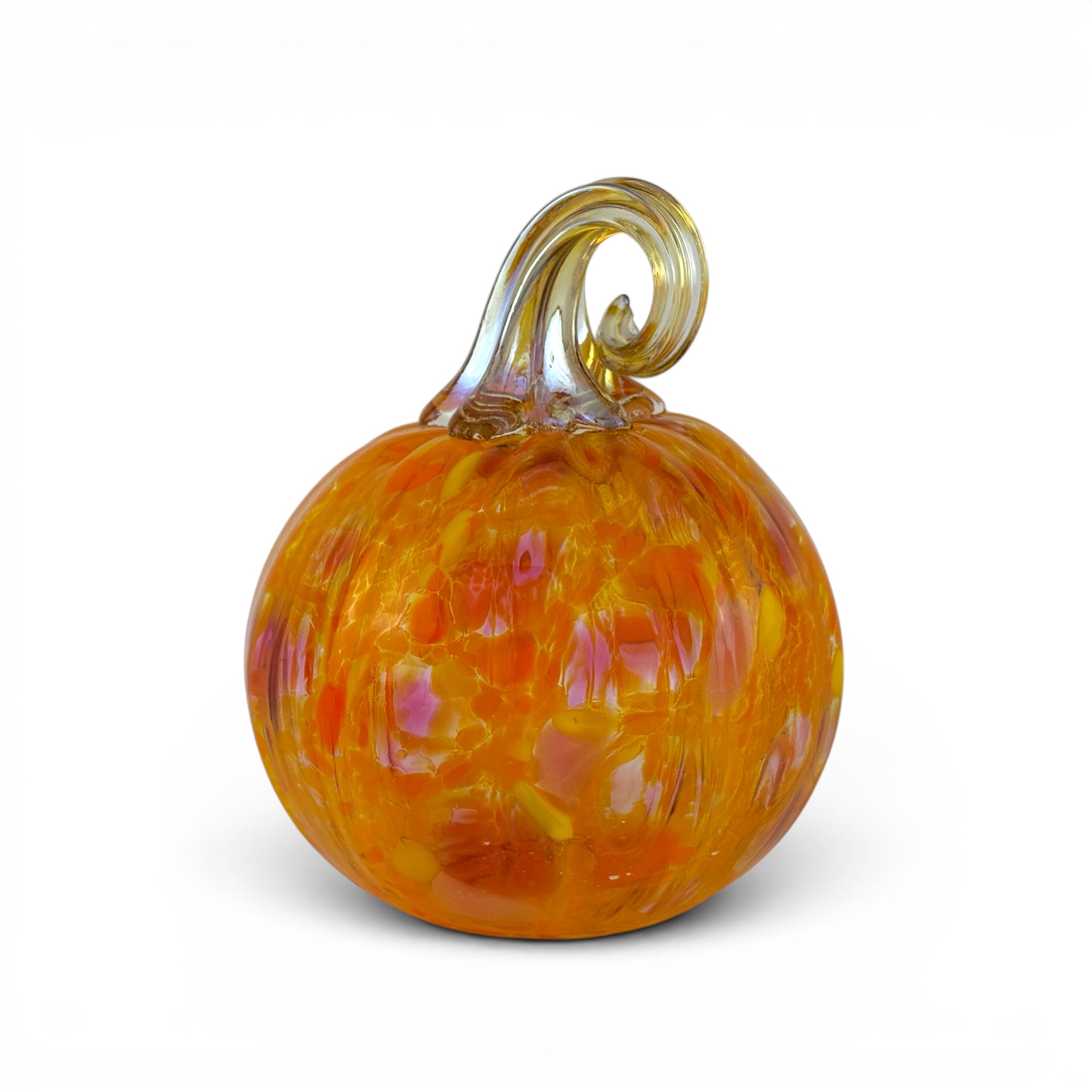 An orange glass pumpkin figurine with a curly stem, featuring swirls of yellow and pink, set against a plain white background.