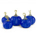 Five decorative glass pumpkins in rich cobalt blue with textured surfaces and metallic gold stems, arranged on a clean white background.