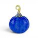 A decorative glass pumpkin sculpture with a textured cobalt blue body and a twisted stem in pale yellow and blue, shown on a white background.