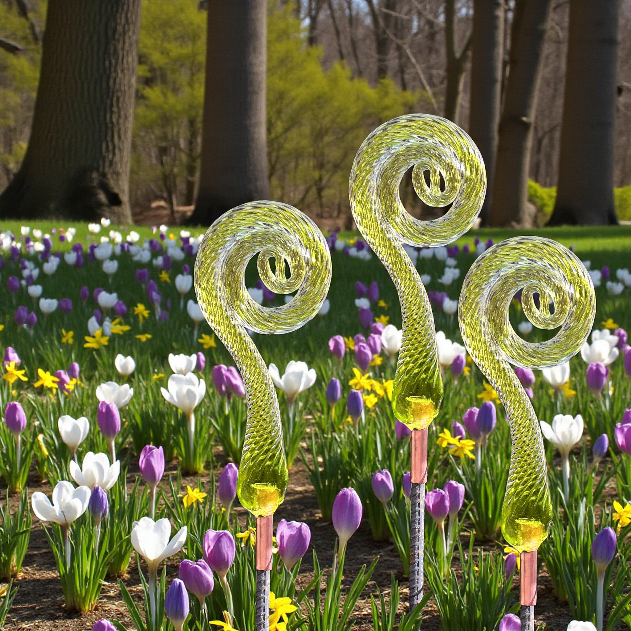 Handcrafted glass fiddlehead ferns in a spring garden are beautiful garden decor