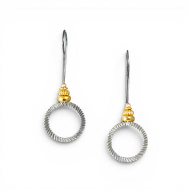 A pair of silver-toned drop earrings with textured circular rings and small gold-toned decorative beads, shown on a plain white background.