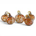 Five hand-blown glass pumpkins with textured orange, red, and white swirls and gold-toned stems, arranged on a white background.
