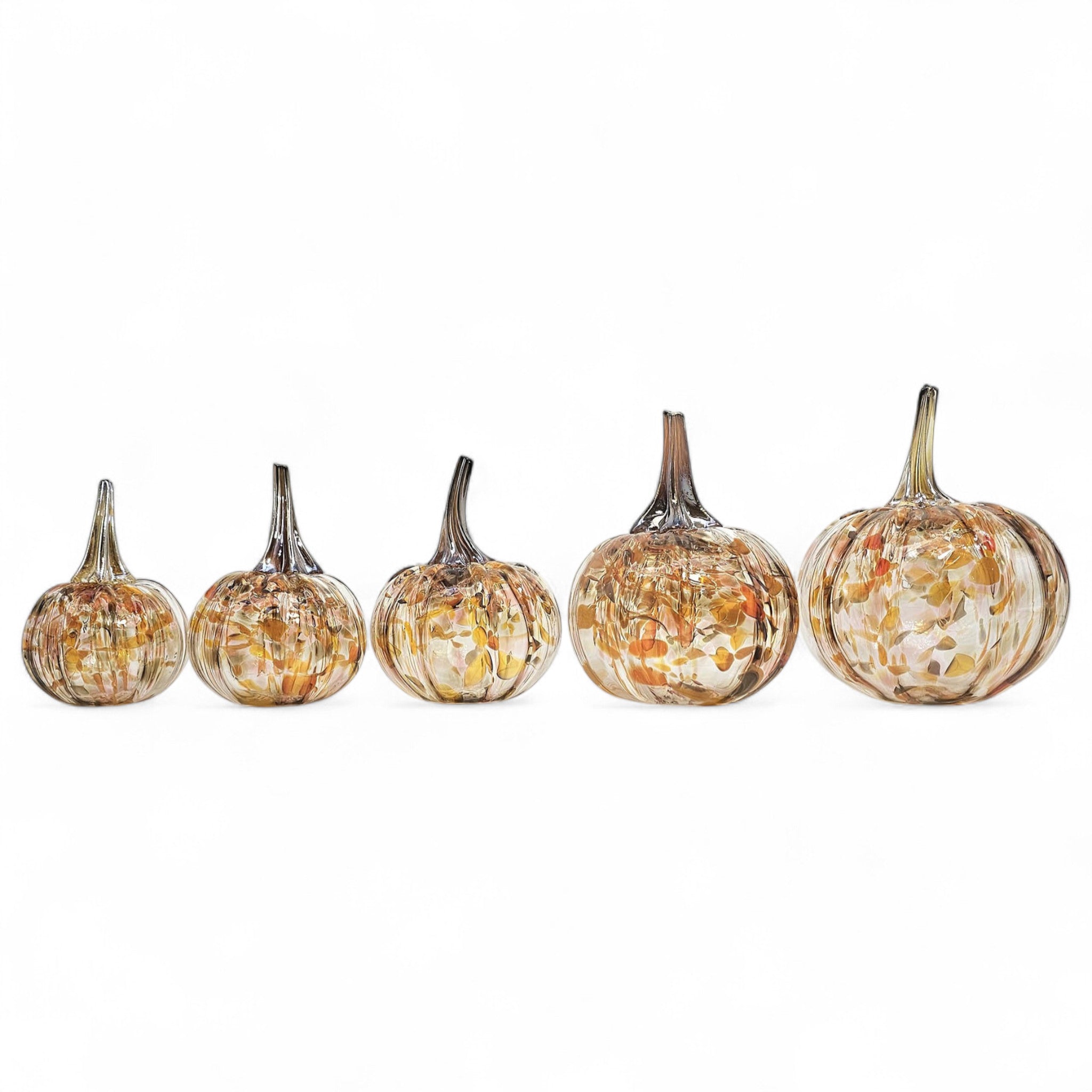 Set of five decorative pumpkins with a mottled finish on a white background