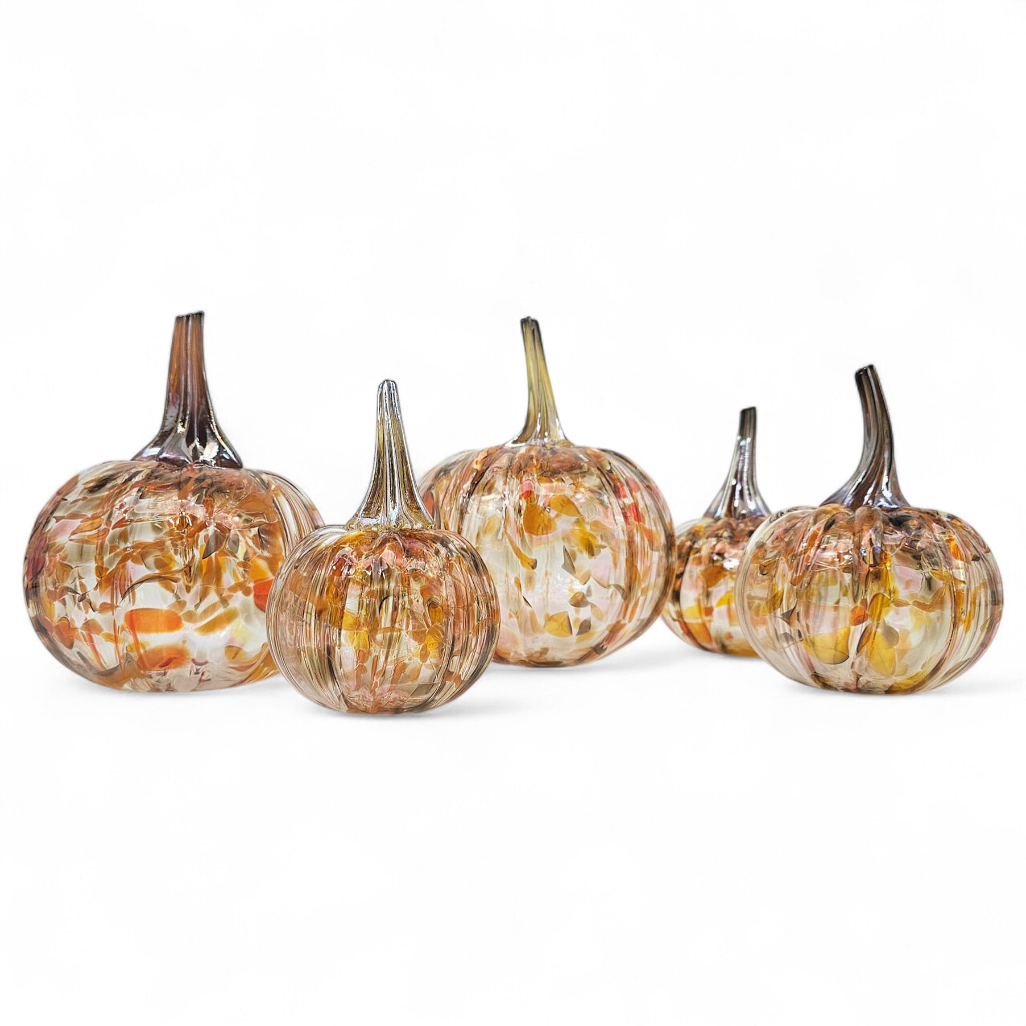 Set of glass pumpkins with marbled design on a white background