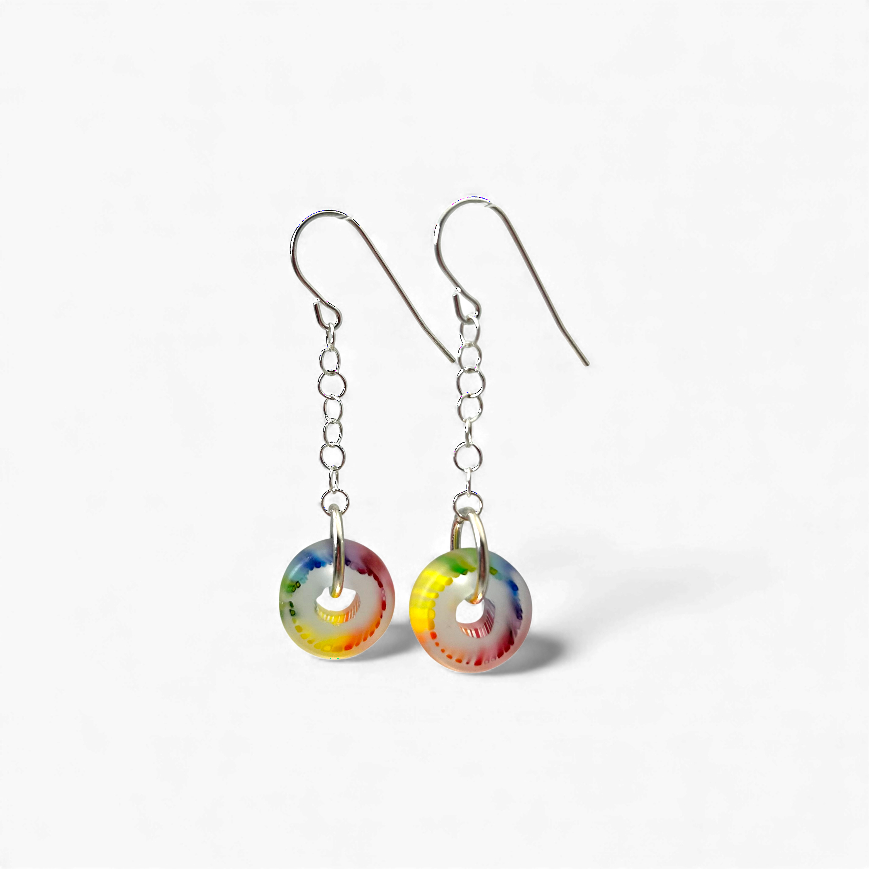 Colorful circular earrings on a white background