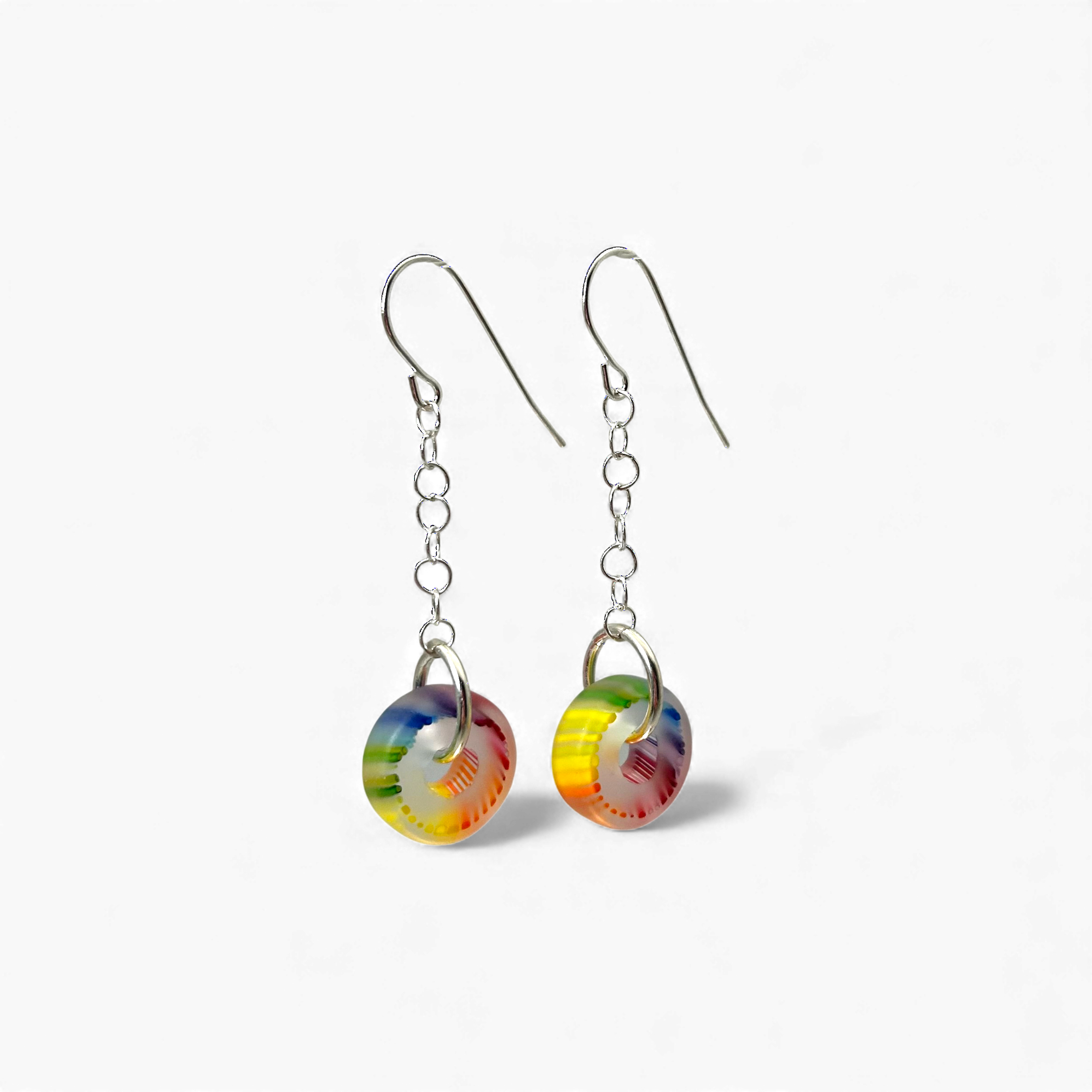 Colorful round earrings on a white background