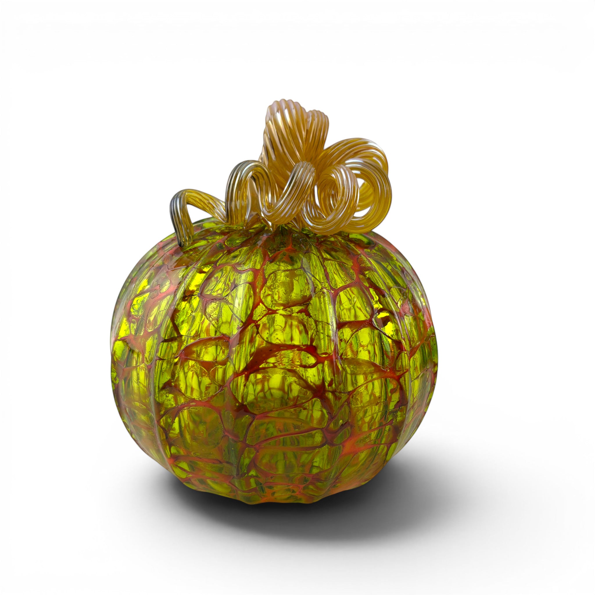 A hand-crafted glass pumpkin with a textured, crackled pattern in yellow, green, and orange-red, featuring a twisted glass stem.  