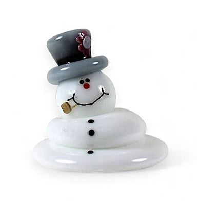 A decorative glass snowman with a top hat and mustache, in a tumbling motion, suggesting it is melting.