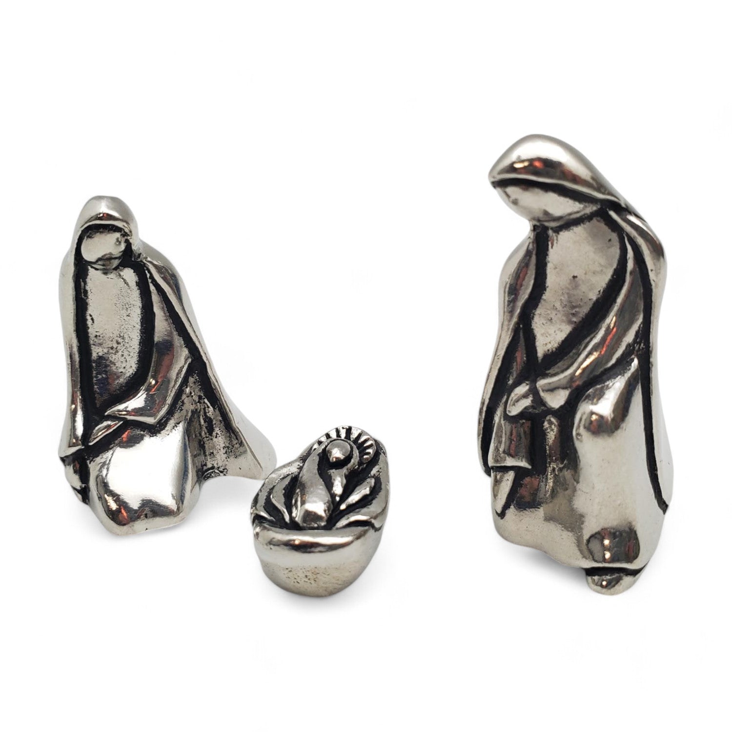 A three-piece pewter miniature nativity set, including figures of Joseph and Mary and a manger, with a velvet storage bag.
