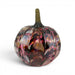 A decorative glass pumpkin with a marbled pattern of black, deep purple, pink, and gold, featuring a twisted dark stem. 