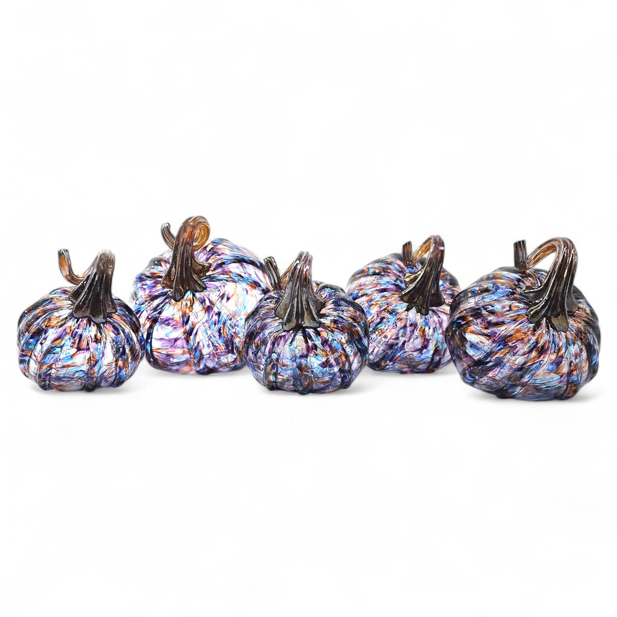 Set of six multicolored glass pumpkins on a white background