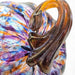 Closeup detail of a colorful glass pumpkin with a golden brown stem