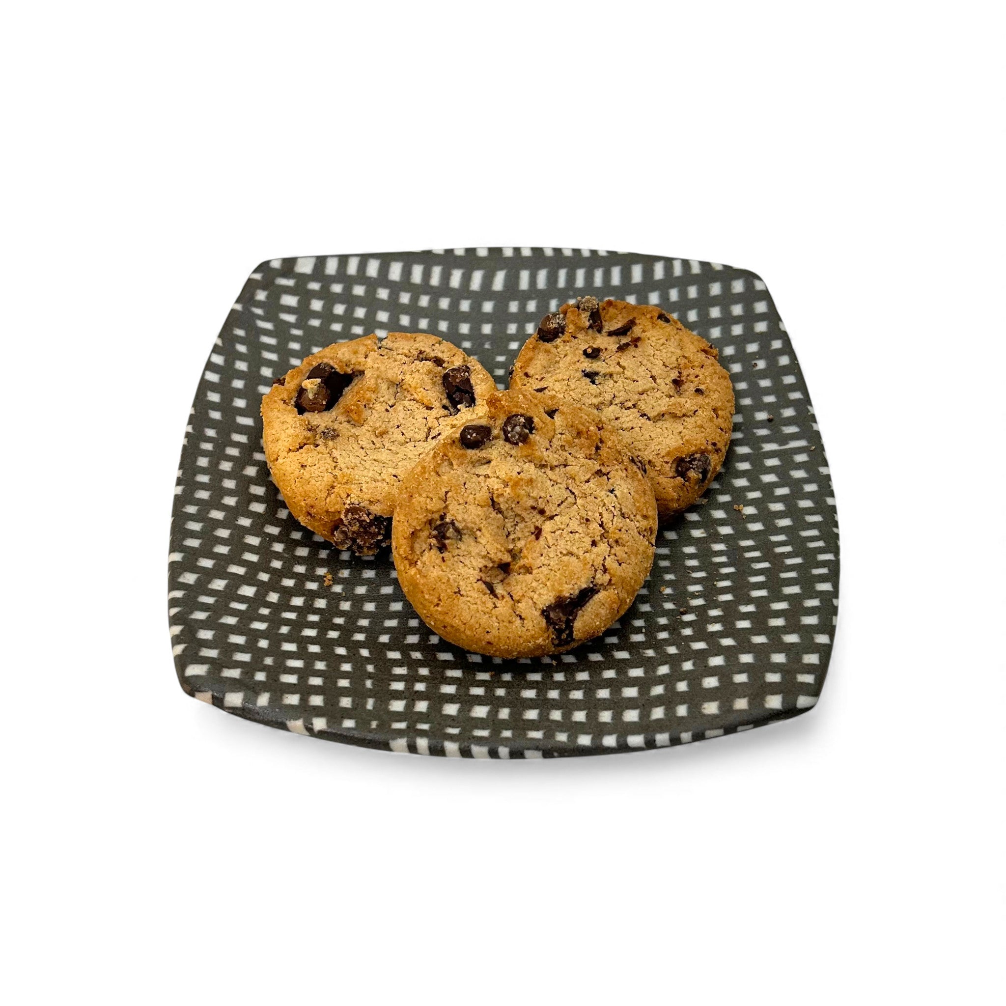 Three chocolate chip cookies on a small hand-built colored porcelain  patterned plate 