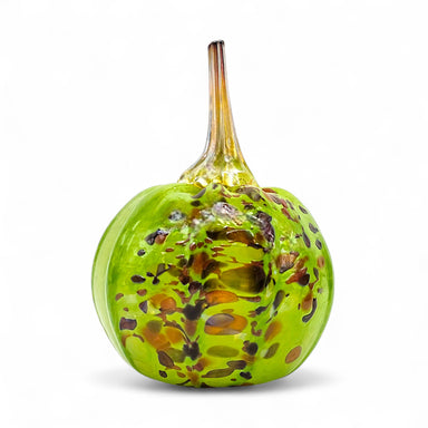 Decorative glass pumpkin with a green and brown speckled pattern on a white background