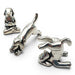Set of silver dog-shaped jewelry pieces on a white background