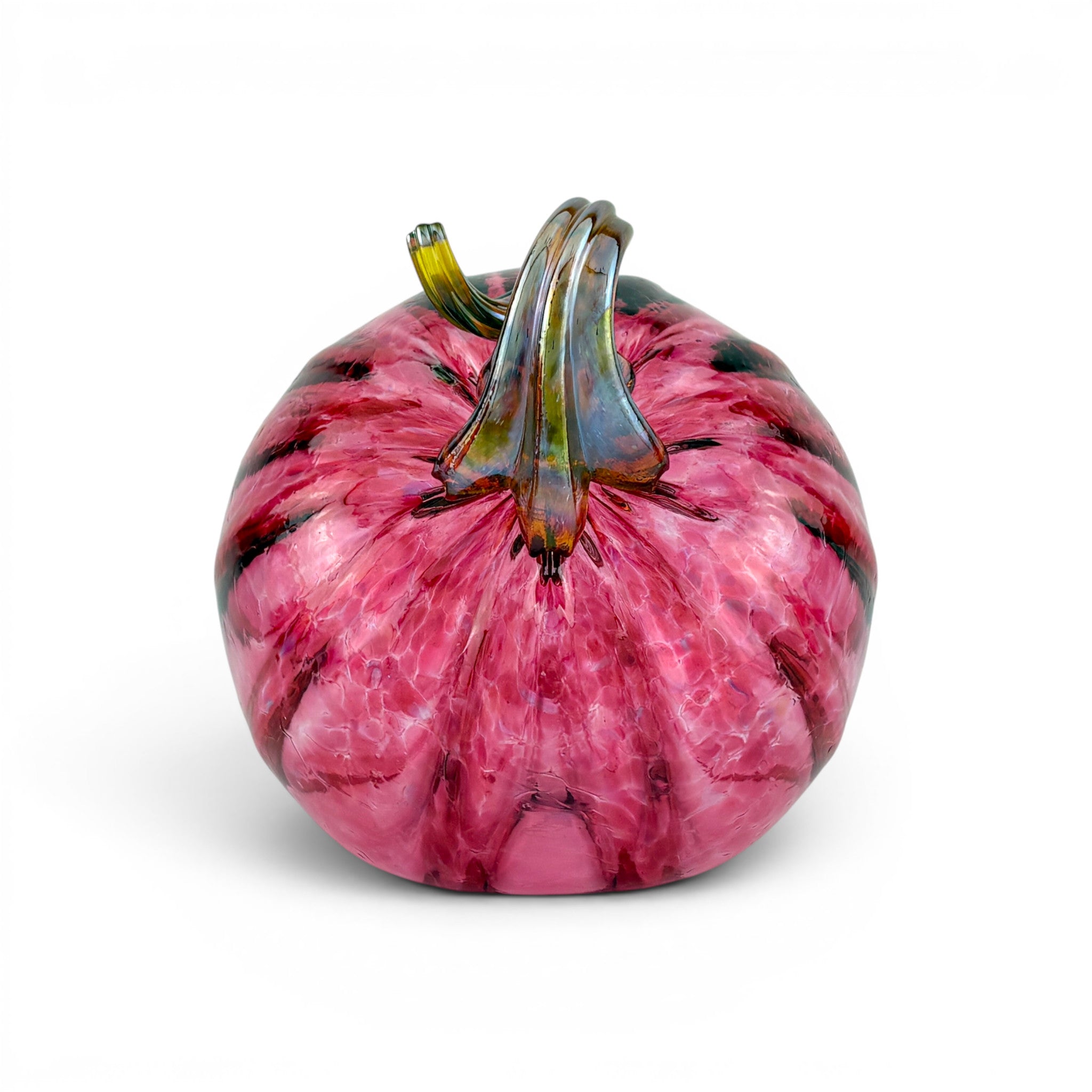 A hand-blown glass pumpkin with a vibrant pink and magenta marbled pattern, featuring a textured stem with green, yellow, and dark blue-green tones, set against a plain white background.
