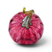 A hand-blown glass pumpkin with a vibrant pink body, dark red marbled veins, and a translucent amber-yellow stem, shown on a white background with a soft shadow.