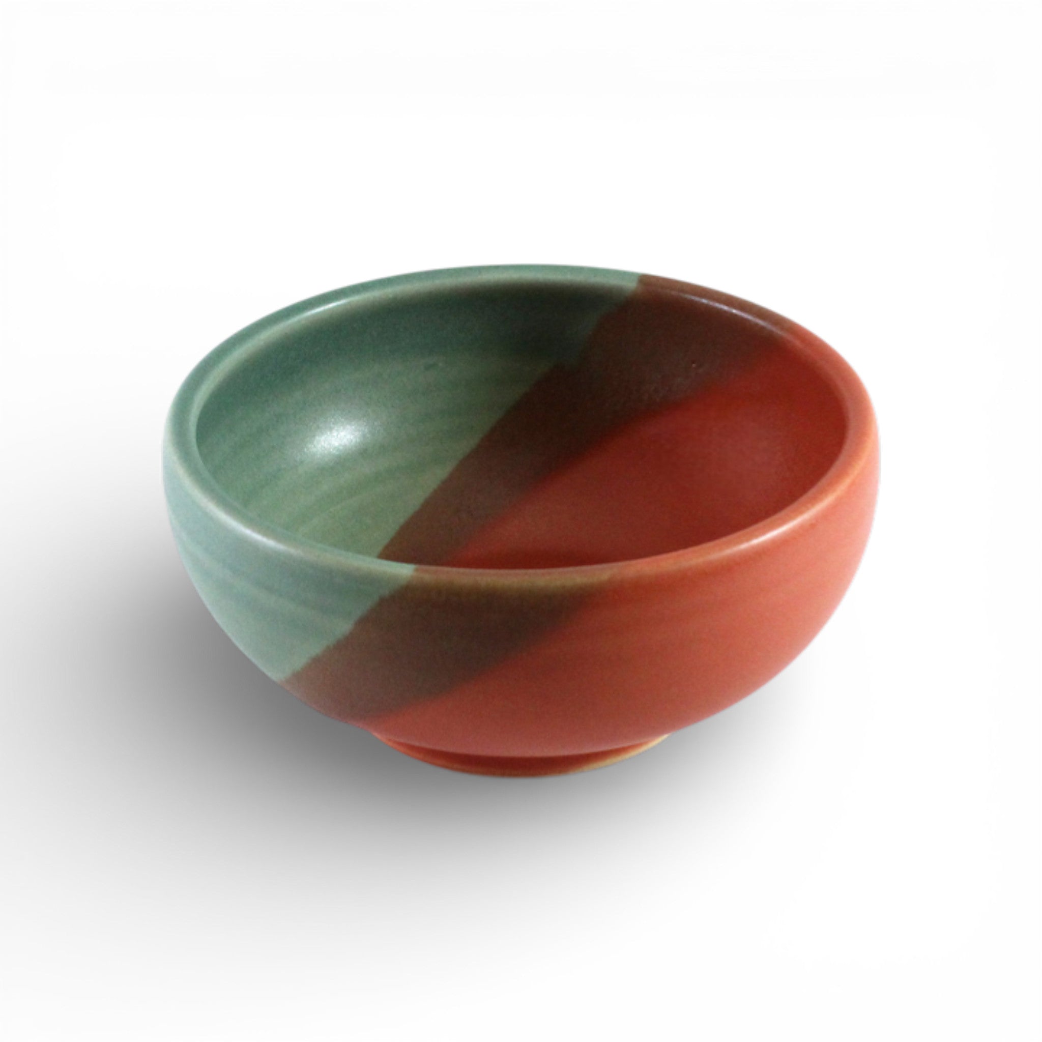 Ceramic bowl with green and red design on a white background