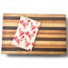 Wooden cutting board with a 100% recycled cotton kitchen towel featuring red roosters 