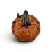A decorative glass pumpkin sculpture with a textured, marbled orange-brown body and a glossy dark stem, shown on a clean white background.
