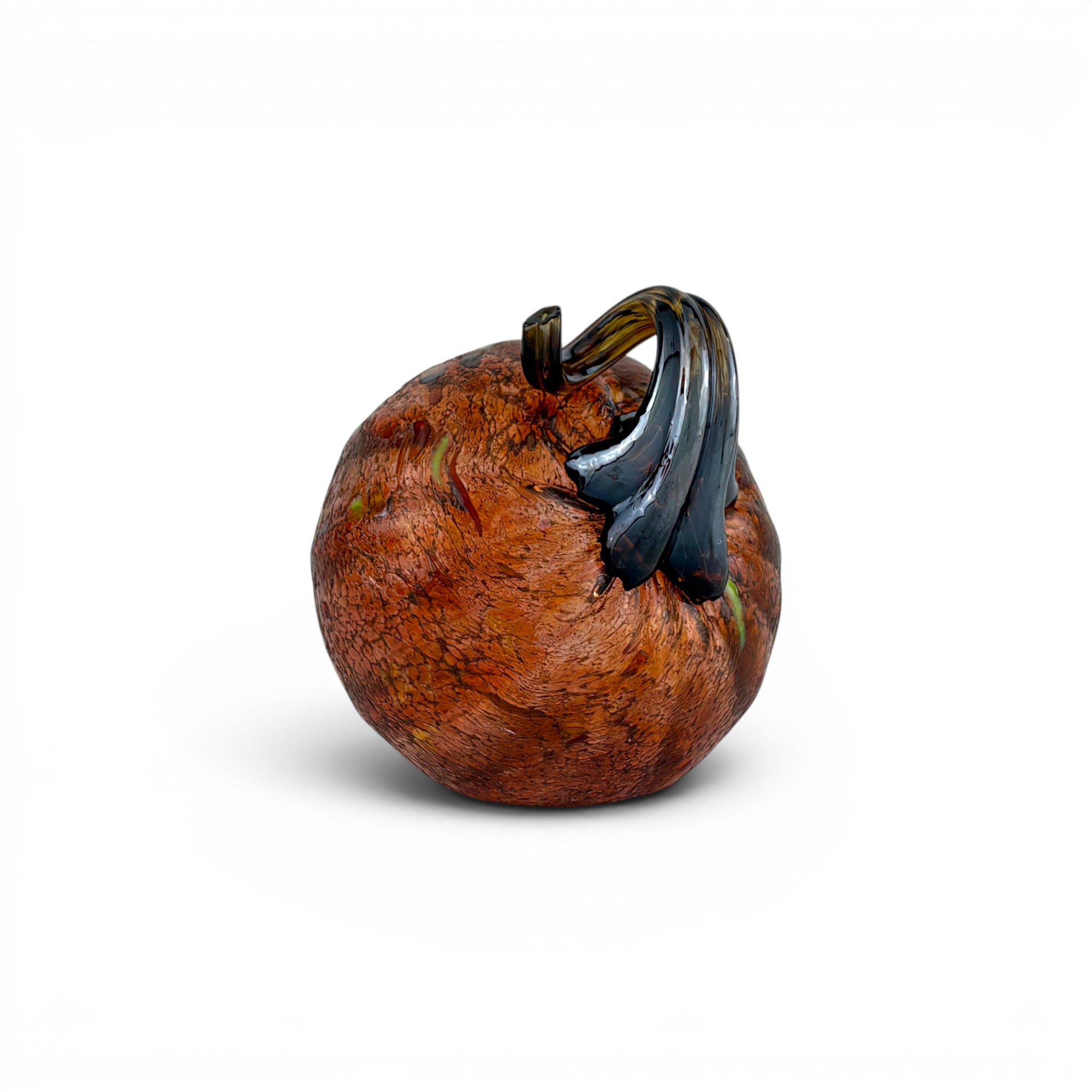 A decorative glass pumpkin sculpture with a textured orange-brown body and a glossy dark green stem, shown on a clean white background.