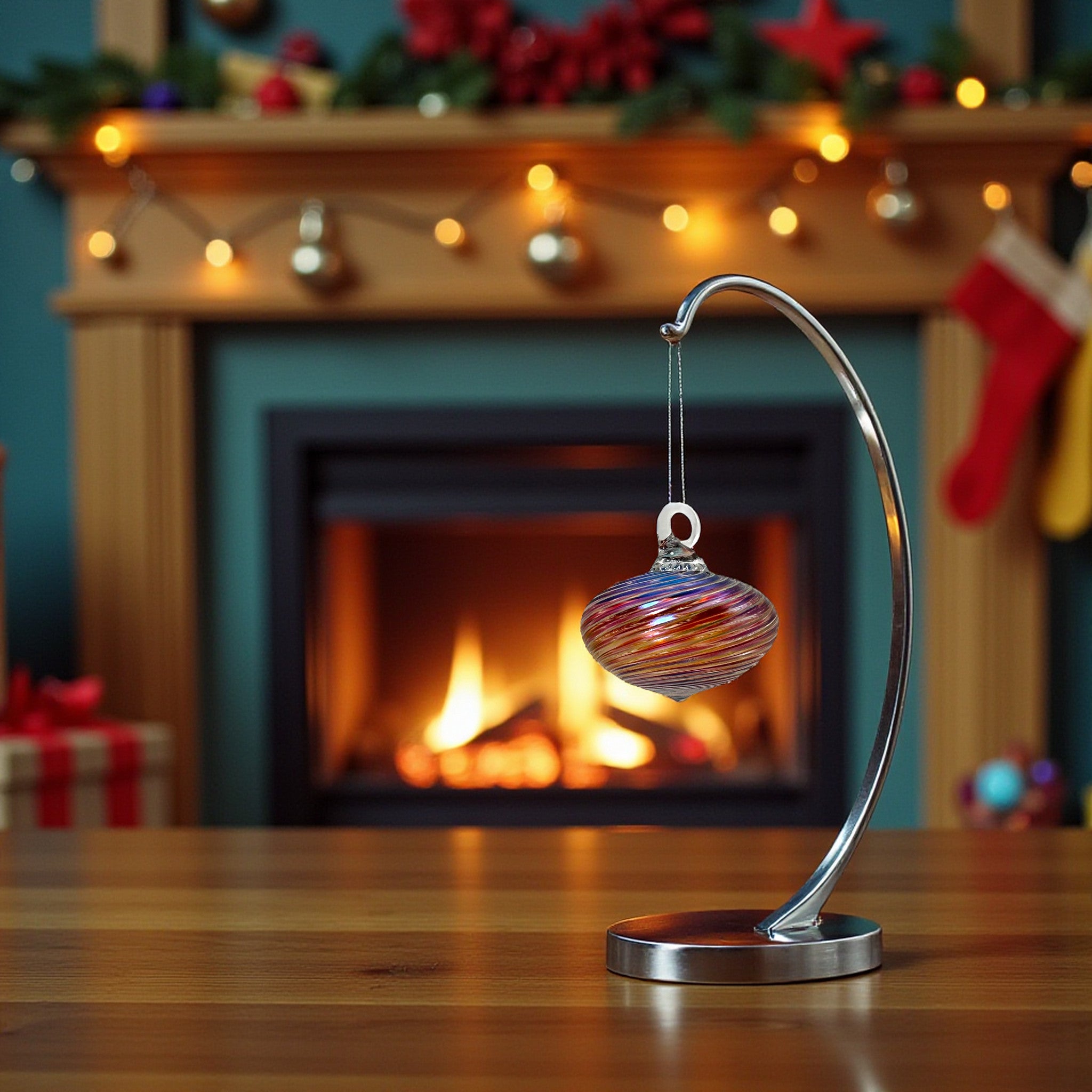 Decorative glass ornament on a stand with a fireplace and Christmas decorations in the background