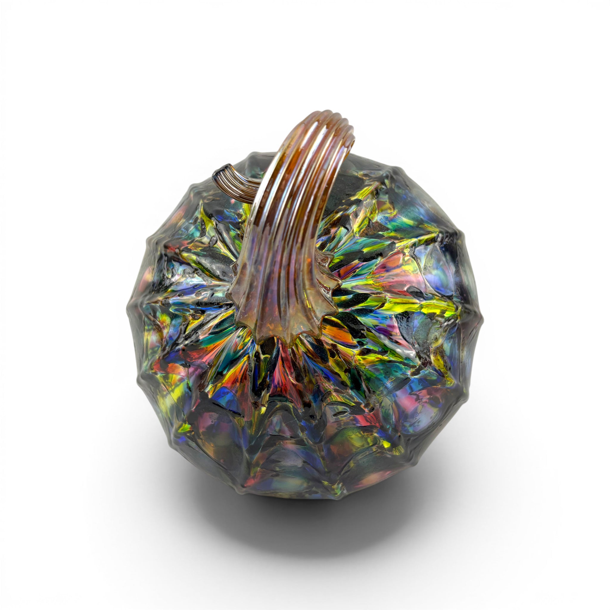 A faceted glass pumpkin with a ribbed handle, featuring an iridescent finish with rainbow reflections on a white background.
