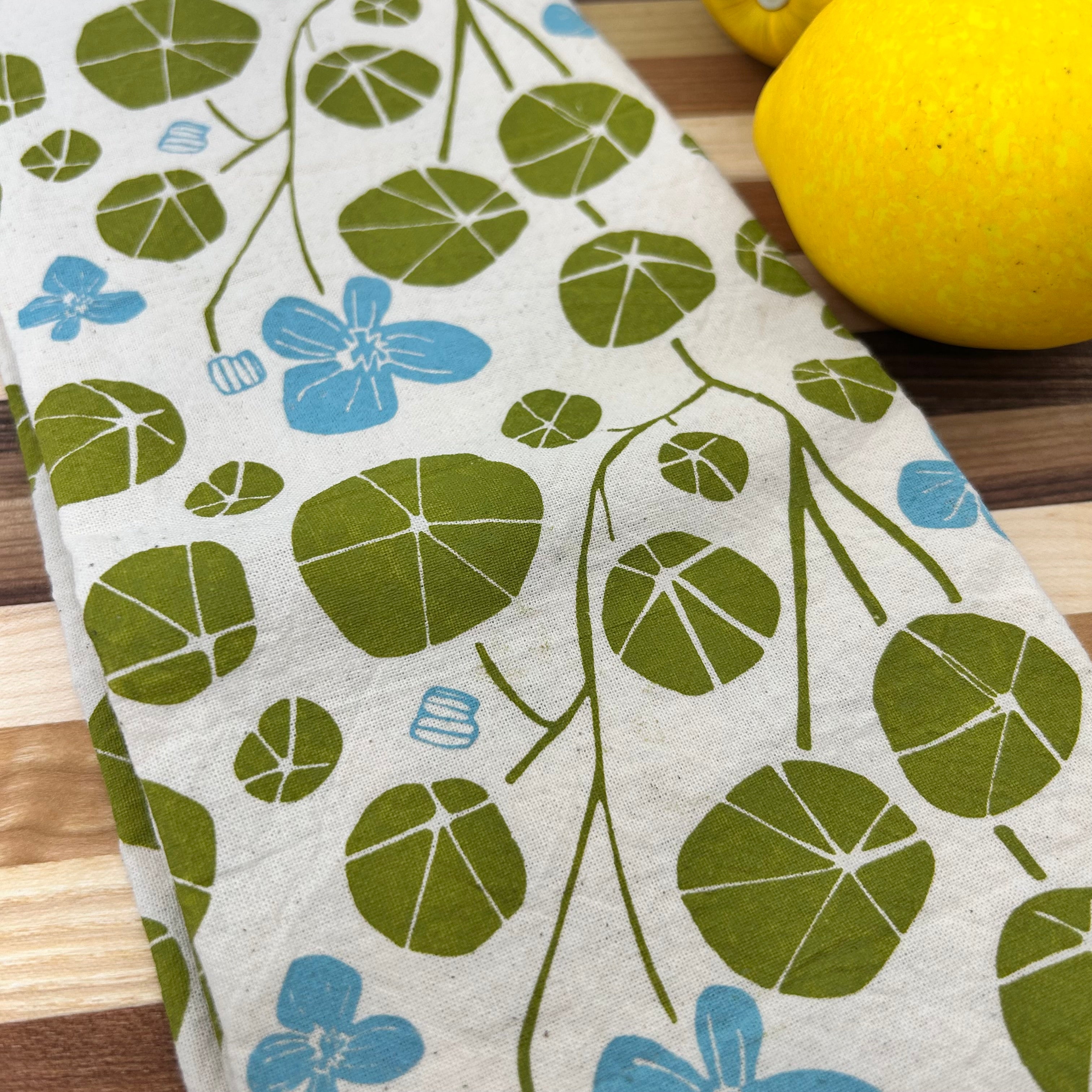 Hand-printed with eco-friendly dyes on 100% cotton, this nasturtium pattern will bring spring into your kitchen!