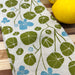 Hand-printed with eco-friendly dyes on 100% cotton, this nasturtium pattern will bring spring into your kitchen!